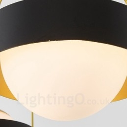 Lámpara de techo moderna contemporánea de 3 luces con baño de cobre y pantalla de cristal esférico blanco y negro.